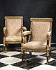 A rare pair of Empire gilt bronze mounted patinated and parcel-gilt carved mahogany fauteuils by Jacob-Desmalter et Cie